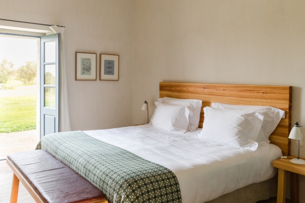 São Lourenço do Barrocal — whitewashed room with oak headboard and olive groves beyond