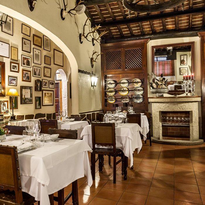 Restaurante Fialho, Évora — antlers, framed awards and white tablecloths