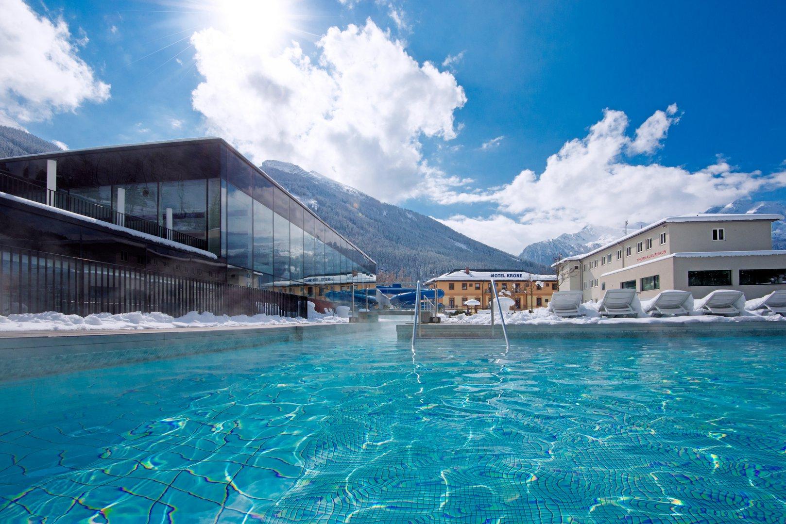 Felsentherme outdoor thermal pool in winter — snow, steam and Alpine peaks