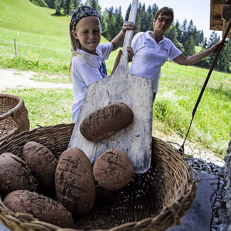 Baking the UNESCO Lesachtaler sourdough bread on a traditional wooden peel